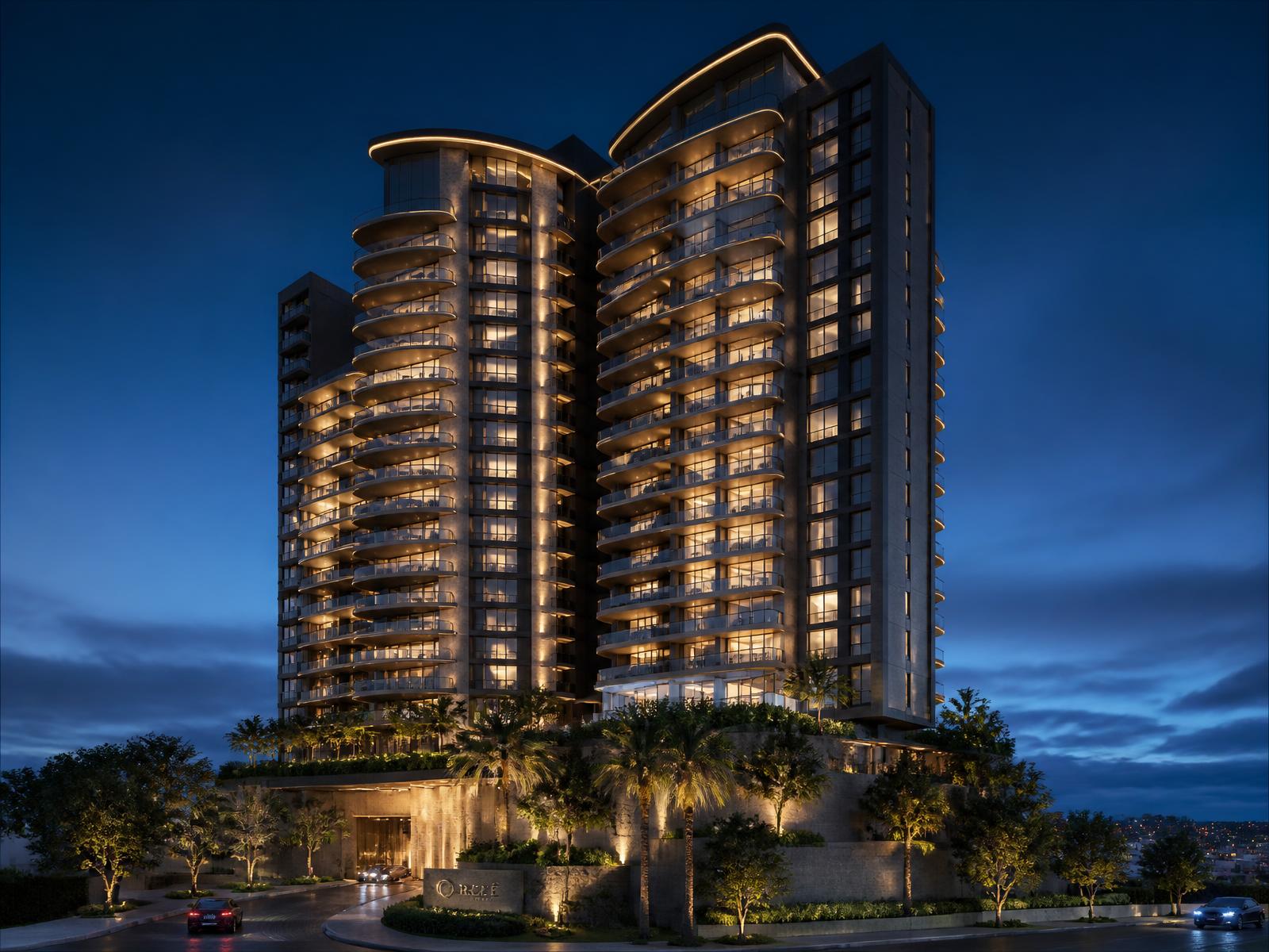 Illuminated luxury residential towers at twilight in Noida
